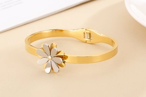 Detail of gold daisy bangle with dual-layer petals and spring clasp mechanism
