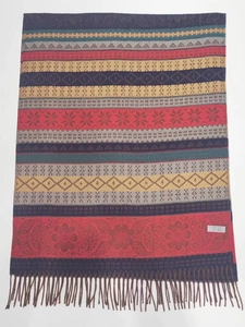 Detailed view of colorful striped ethnic scarf with soft fringes and brand label