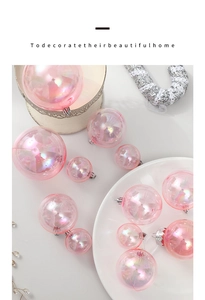 Close-up of pink iridescent Christmas ball ornaments with holographic finish on a tray