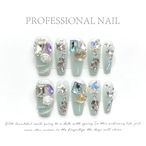 Detailed view of handmade press-on nails with luxury rhinestones and 3D white roses
