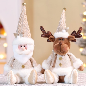 Detailed view of champagne gold Christmas Santa and reindeer plush dolls with bell accents