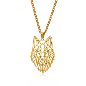 Detailed macro shot of a hollow geometric gold wolf head pendant necklace with fine chain