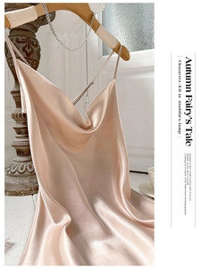 Detail of champagne satin slip dress featuring elegant cowl neck and thin straps