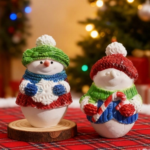 3D Christmas snowman figurines with candy cane and snowflake on festive table