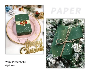 Detail of dark green gold-foiled wrapping paper on festive gift boxes with snow scenery