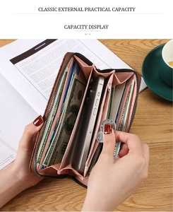 Brown long wallet detail showing pink interior slots with phone and card storage