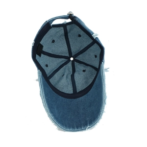 Detailed interior view of vintage distressed denim cap showing inner structure and tags