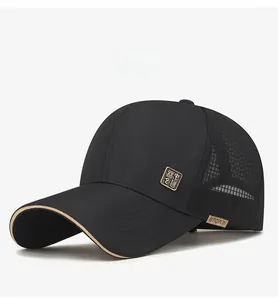 Detail of black breathable mesh baseball cap with metal logo and beige sandwich brim