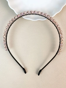Macro detail of handmade crystal beads hand-wrapped on a metal bridal headband