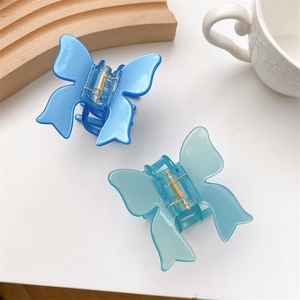 Elegant butterfly hair claws in bright blue and translucent teal with metal spring