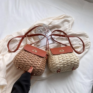 Chic handmade straw crossbody bag in brown and cream with leather flap and strap
