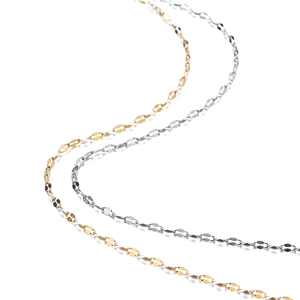 Detailed macro view of S-shaped gold and silver stainless steel link chains on white background