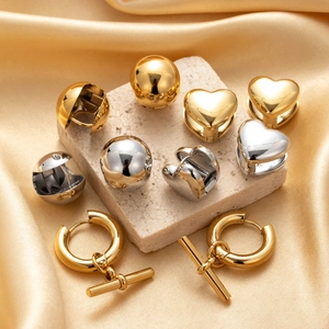 Polished titanium steel earrings set in heart and ball shapes with gold and silver finishes
