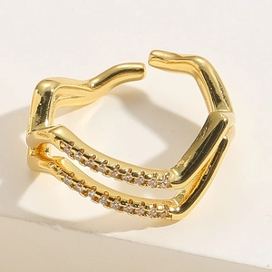 Macro detail of golden double-layer open ring with white zircon stones and stars