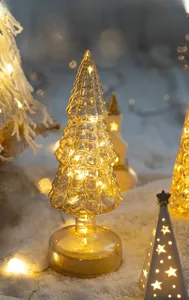 Macro shot of glass Christmas tree lamp with warm LED light and textured scales
