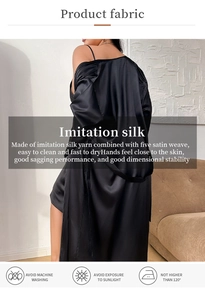 Detail of black imitation silk bathrobe showing smooth texture and laundry care icons