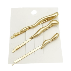 Set of 3 minimalist irregular gold wave metal hair clips on a white display card