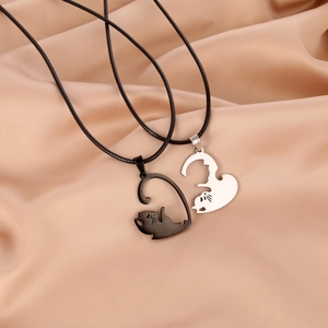 Cat couple necklaces in black and silver stainless steel forming a heart shape on silk