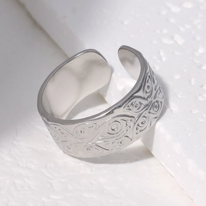 Detailed macro view of vintage evil eye engraving on silver stainless steel ring