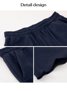 Detail design of navy wide leg trousers with drawstring waist and waffle texture fabric