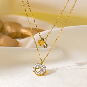Macro shot of 18K gold plated double layer necklace with heart and zircon pendants