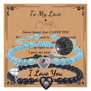 Close-up of magnetic heart clasp on turquoise and matte black bead couple bracelets