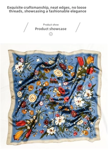 Detail of sky blue silk-like square scarf with floral tulips and butterfly patterns
