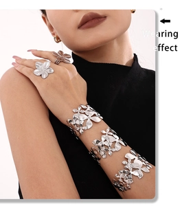 Detail showing high-quality 18K gold plated flower pattern texture on wide metal cuff