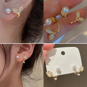 Detailed views of French baroque pearl earrings with tulip leaf design and gold finish