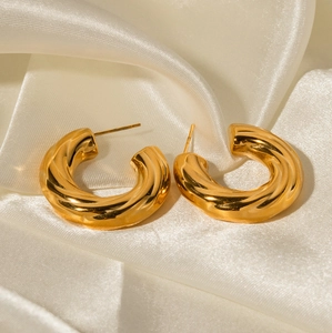 Polished 18K gold plated chunky twisted C-shaped hoop earrings for women on silk