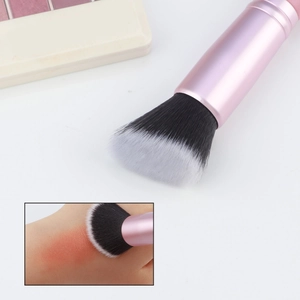 Detailed macro view of soft gradient bristles on a pink metal handle foundation brush