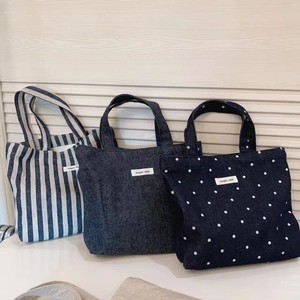 Three minimalist denim canvas tote bags in stripes, solid color, and polka dot styles