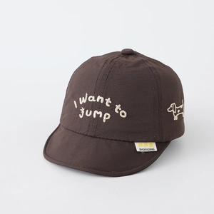 Detailed view of dog embroidery and slogan on deep brown baby soft brim baseball cap