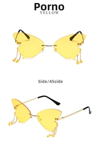 Close-up of butterfly sunglasses with yellow lenses, metal chains and side view details