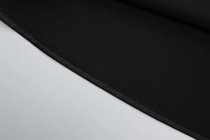 Detailed close-up of fine stitching and hemline on a black bodycon tube dress fabric