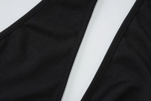 Macro shot of precise stitching and black textured fabric on backless dress detail