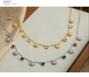 Detailed close-up of gold and silver shell pendants with colorful zircon on satin