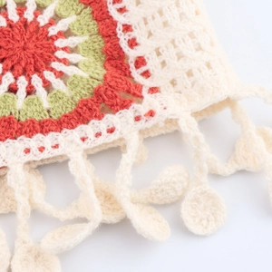 Bohemian style crochet knit short cardigan with floral patterns and fringe details