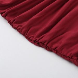 Detailed close-up of dark red knitted fabric featuring elastic ruched stitching and textures