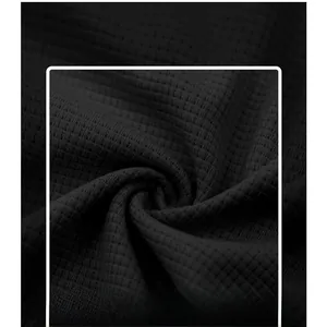 Close-up of deep grey waffle weave fabric texture with breathable grid structure