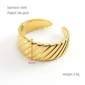 Detail of 8mm wide spiral textured 18k gold plated stainless steel open ring