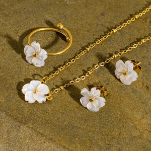 Detailed view of the 18K gold titanium necklace and flower ring jewelry set for women
