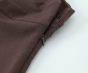 Detailed view of the dark brown mini dress featuring a seamless concealed zipper