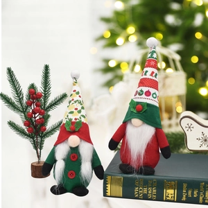Close-up of Christmas gnomes in red and green outfits on vintage books with lights