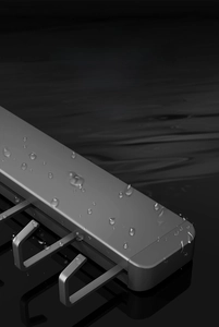 Macro shot of waterproof grey metal hooks with water drops on space aluminum surface