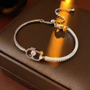 Macro shot of 18k gold plated chain bracelet featuring a dancing zircon in oval pendant