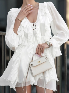 Elegant white chiffon long sleeve mini dress with ruffled details and V-neck tie closure