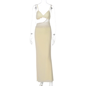 Detailed view of pale yellow maxi dress featuring waist cut-outs and sheer mesh patchwork