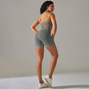 Detailed back view of seamless ribbed sports bra and high-waist biker shorts in sage green