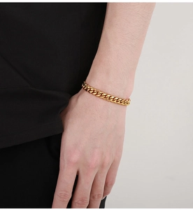 Side view of golden Cuban link bracelet on wrist showing polished and sandblasted finish